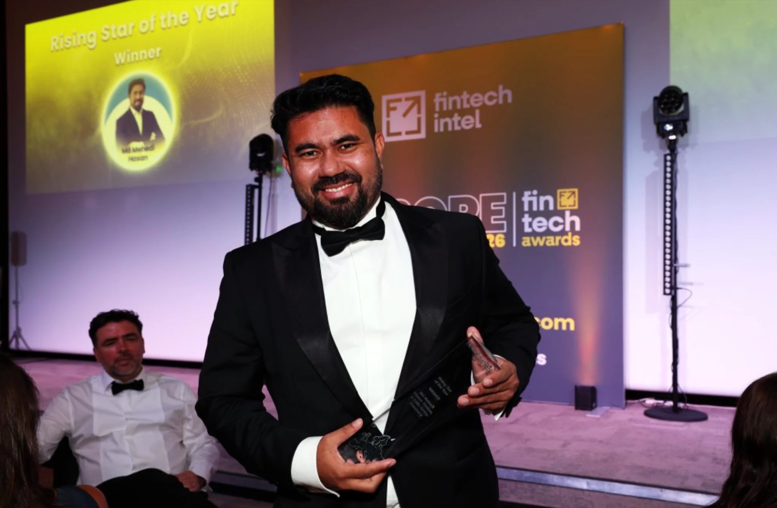 Mehedi Hasan smiling with his trophy at the European FinTech Awards 2026, in front of a screen announcing him as Rising Star of the Year winner